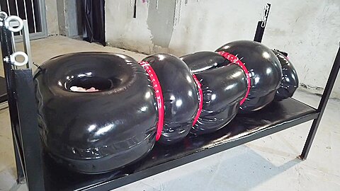 Inflatable Rubber Sleepsack :: Blonde woman restrained in latex bondage device