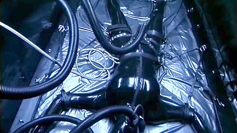Latex Suit Spreadeagle Remote Controlled :: Latex bondage scene with vibrating harness setup