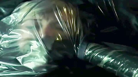 Latex Breathplay :: Blonde woman gags herself with plastic sheeting